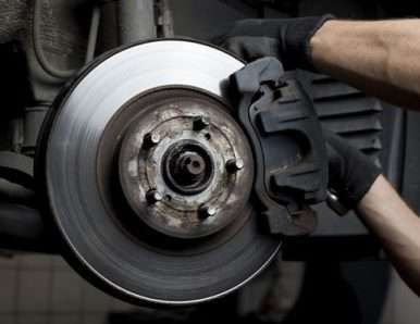 Closeup of car mechanic repairing brake pads